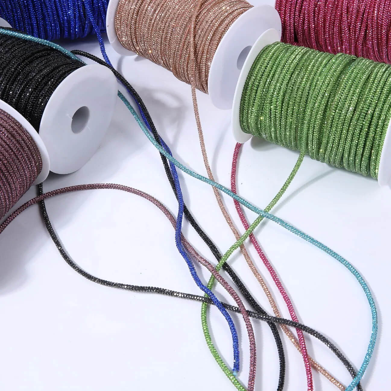 Luxurious rhinestone rope (crystal cord) glittering with multi-faceted stones on a sturdy braided cord.