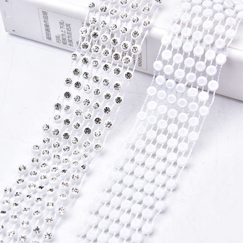 Plastic rhinestone banding trim with round crystal stones on white plastic base for garment decoration